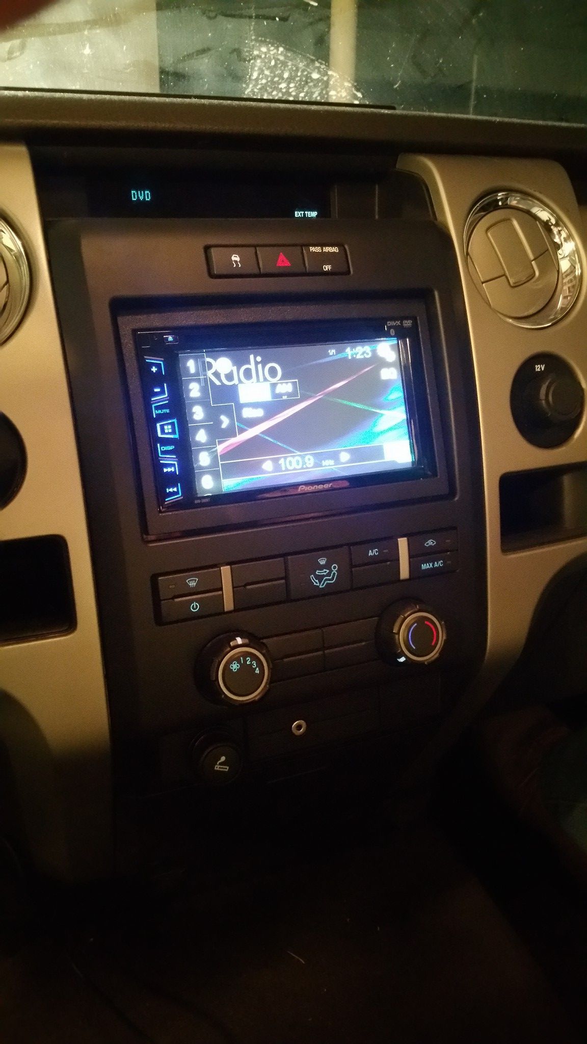 Dashboard of a Ford truck with an aftermarket radio display. The dashboard is black and silver.