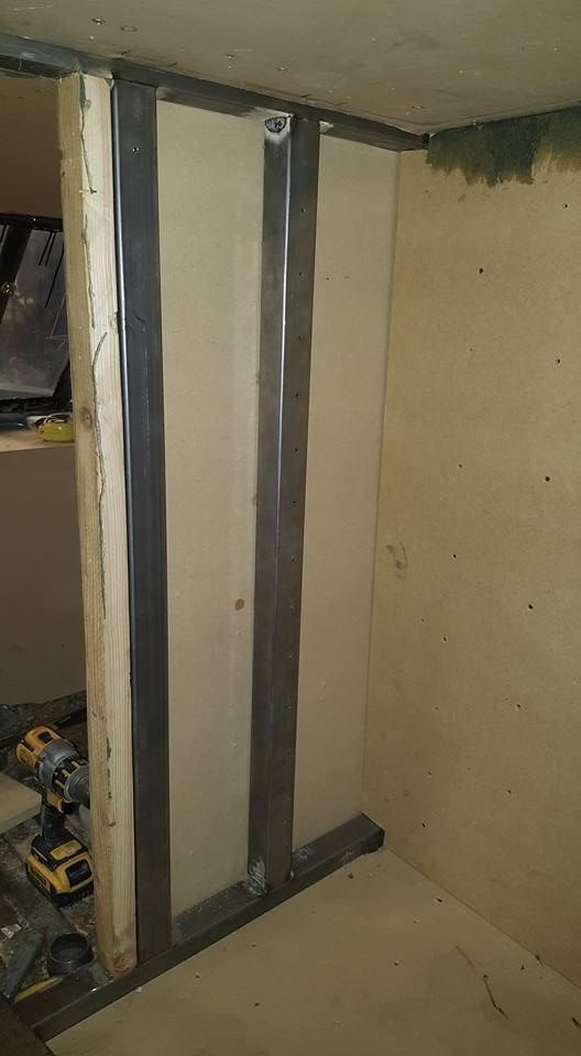 Interior corner with metal studs and drywall partially installed, suggesting construction.