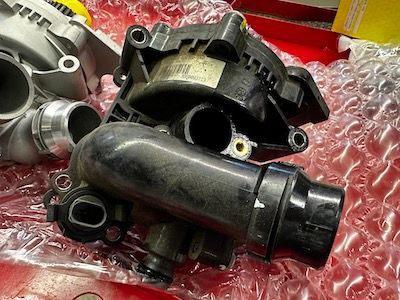 A turbocharger is sitting on top of a piece of bubble wrap.