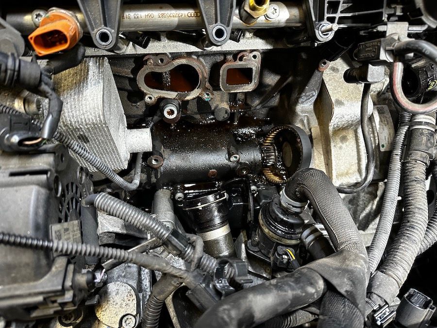 A close up of a car engine with a lot of wires coming out of it.