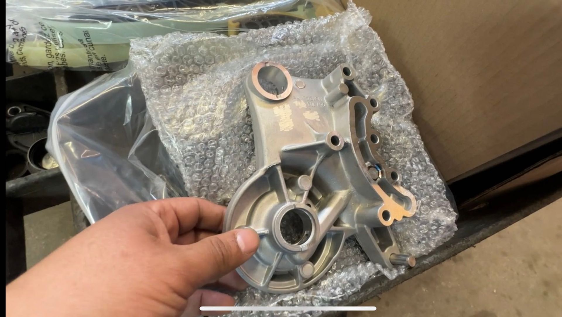 A person is holding a piece of metal in their hand.