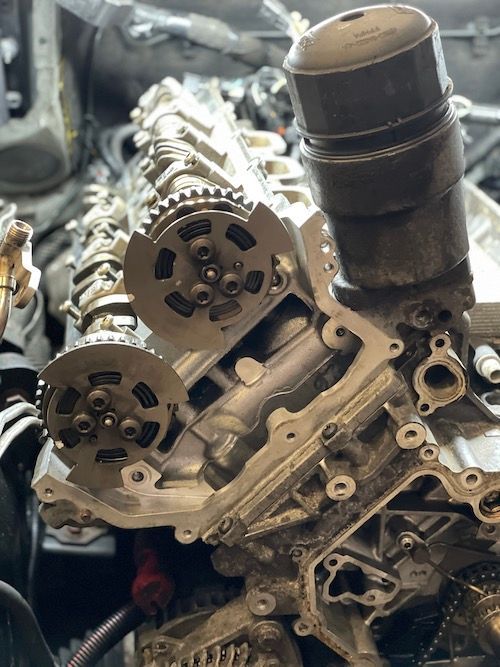 A close up of a bmw engine that is being worked on.