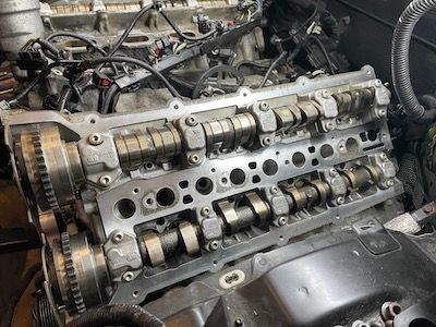 A close up of a car engine being worked on.