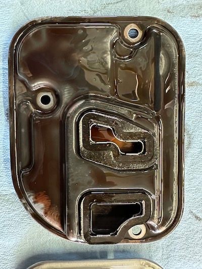 A close up of a metal object on a blue surface.