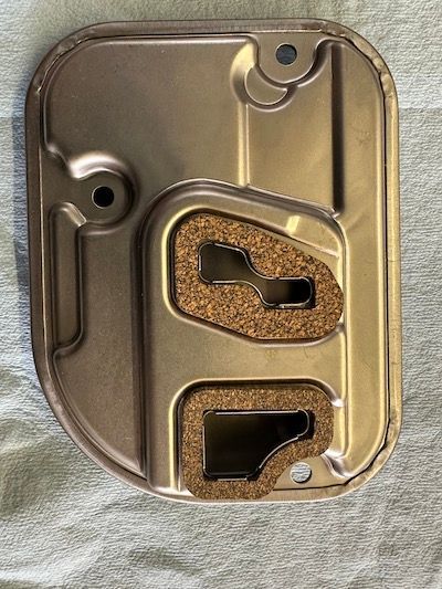 A metal object with a hole in the middle is sitting on a towel.