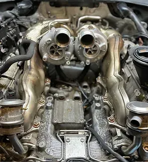 A close up of the engine of a car with two turbochargers.