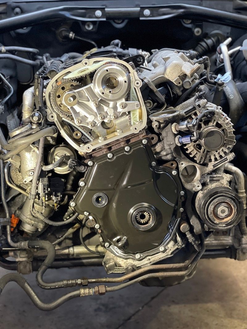 A close up of a car engine with the hood open.