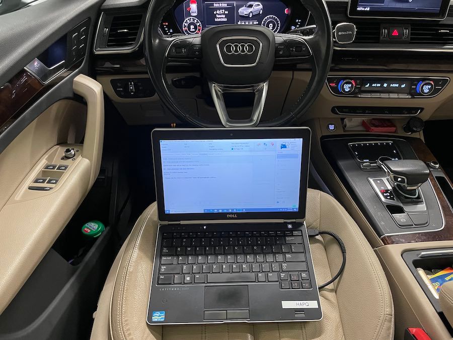 A laptop is sitting in the driver 's seat of a car.