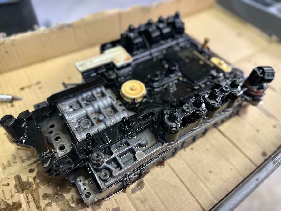 A piece of metal is sitting on top of a wooden table.