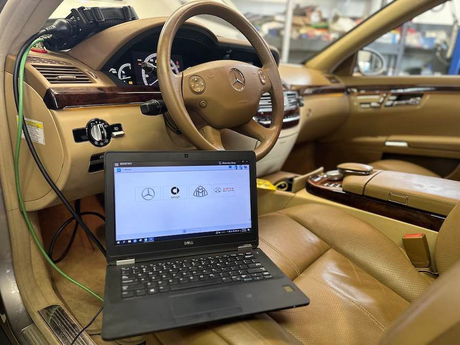 A laptop is sitting in the driver 's seat of a car.