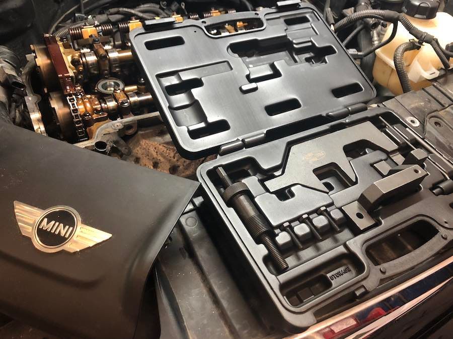 A mini cooper engine is being worked on by a mechanic