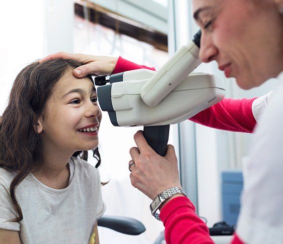 Eye Care Professionals — Doctor Checking The Eye of The Girl in Delran, NJ