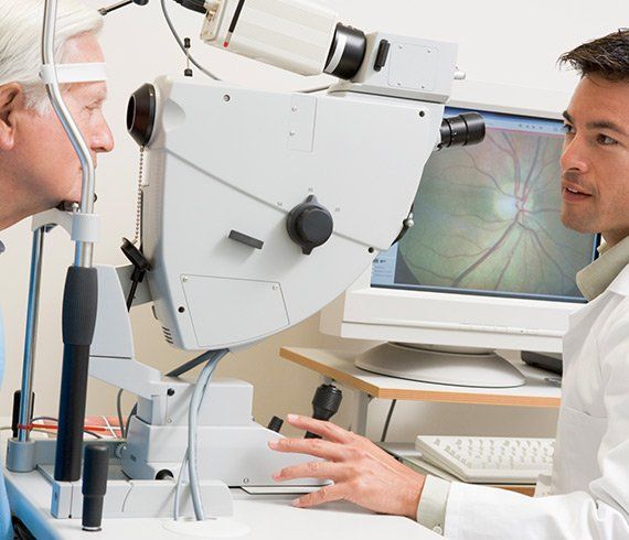 Optometric Services — Doctor Checking The Eye of The Old Man in Delran, NJ