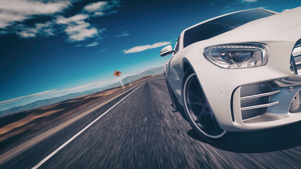 A White Car Is Driving Down A Highway — Rapid Auto Refinish in Toowoomba, QLD