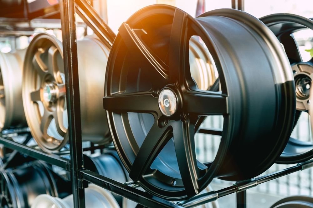 A Bunch Of Wheels Are Stacked On Top Of Each Other On A Rack  — Rapid Auto Refinish in Toowoomba, QLD