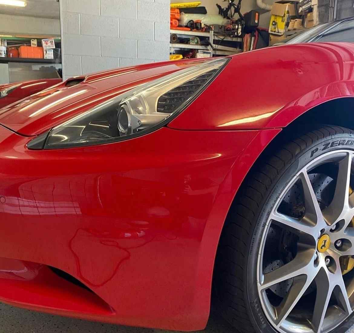 A Red Sports Car Is Parked In A Garage  — Rapid Auto Refinish in Toowoomba, QLD 