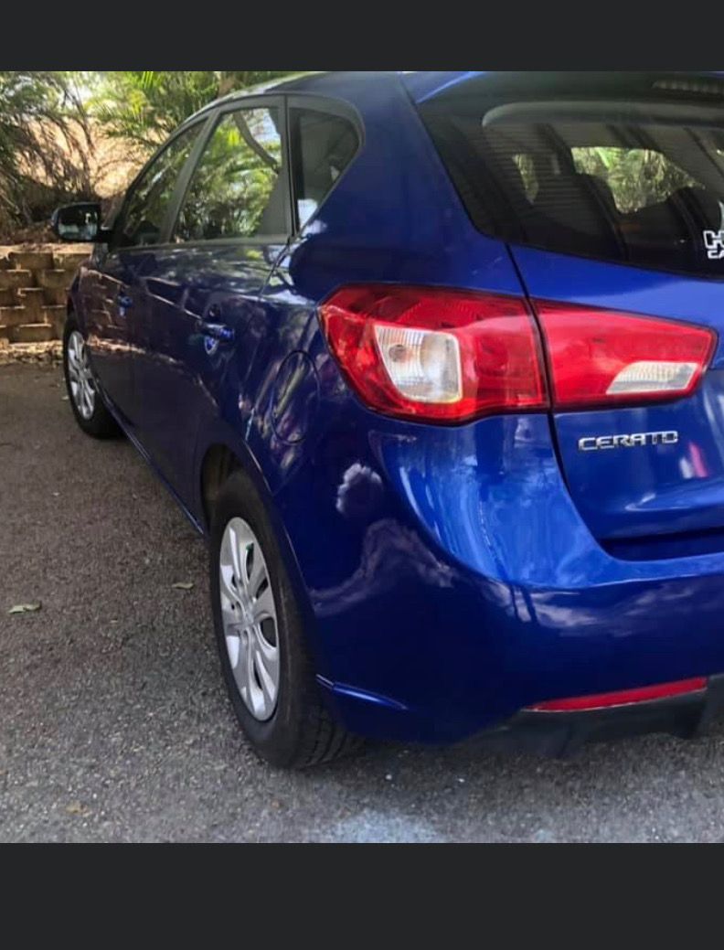 A Blue Car With A Red Tail Light Is Parked   — Rapid Auto Refinish in Toowoomba, QLD 
