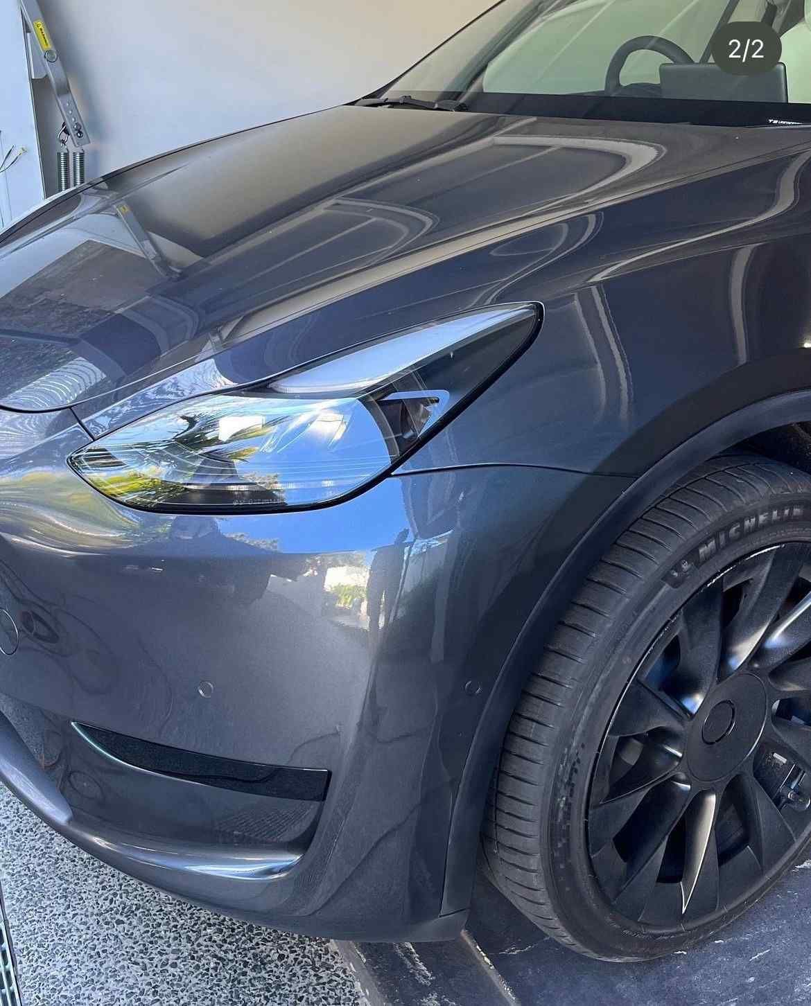 A Black Tesla Model Y Is Parked In A Garage  — Rapid Auto Refinish in Toowoomba, QLD 