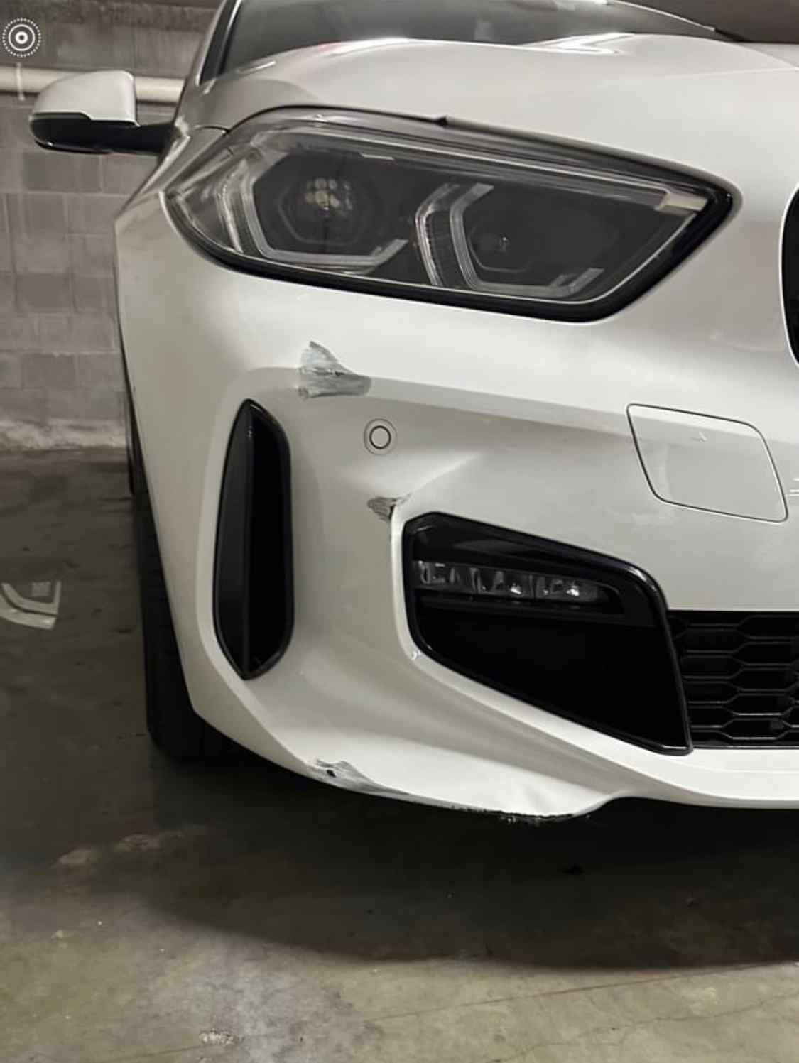 A White Bmw Is Parked In A Parking Garage — Rapid Auto Refinish in Toowoomba, QLD 
