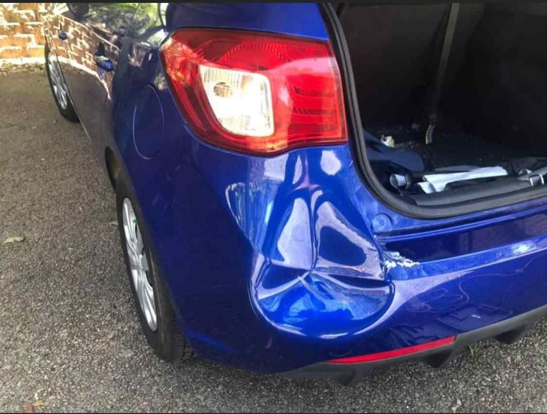 A Blue Car With A Damaged Bumper Is Parked In A Driveway  — Rapid Auto Refinish in Toowoomba, QLD 