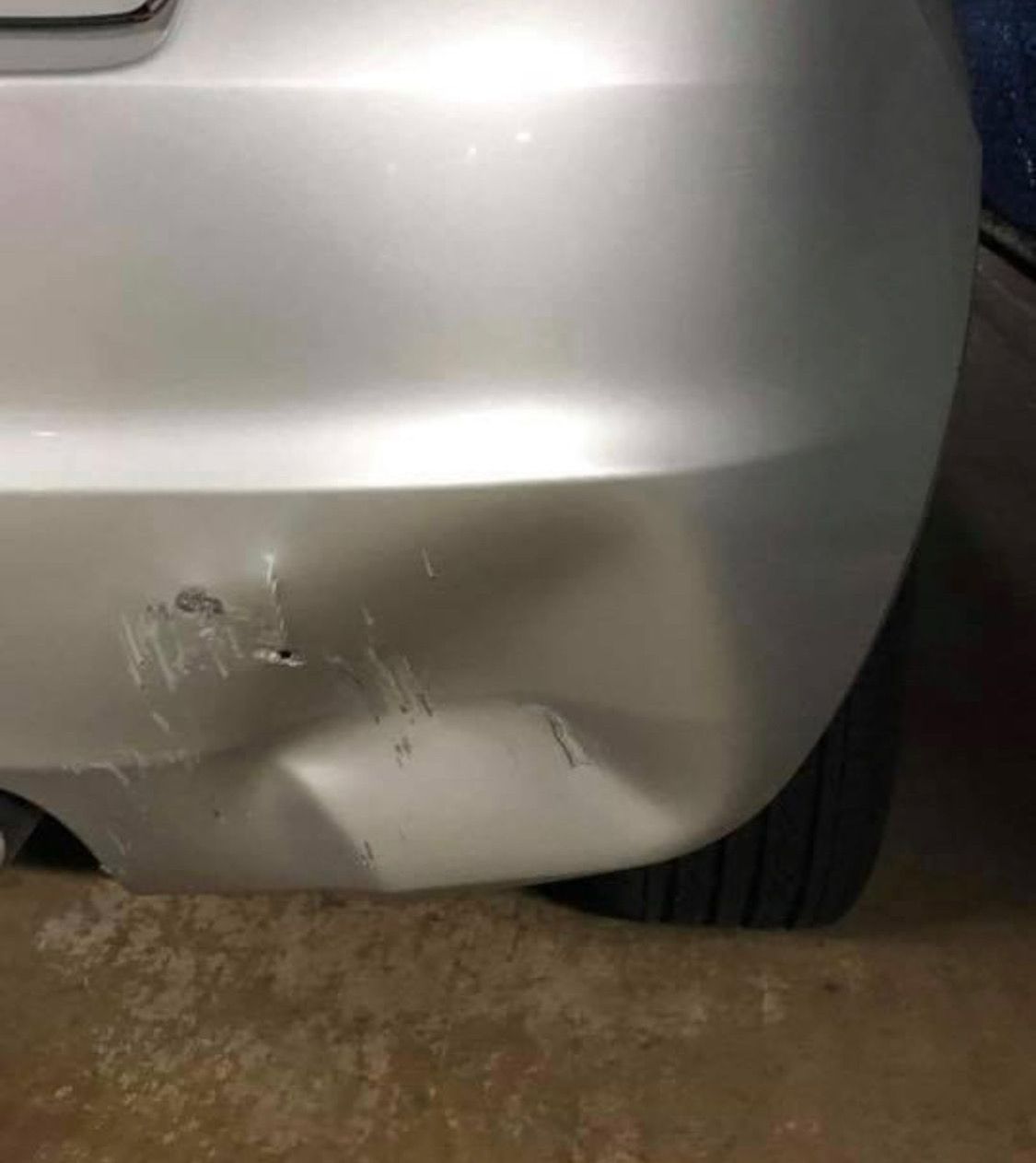 A Silver Car With A Damaged Bumper Is Parked In A Garage  — Rapid Auto Refinish in Toowoomba, QLD 