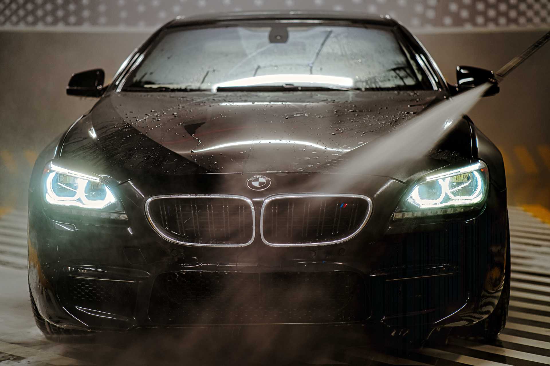 water spraying on a black bmw hood