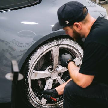 A man is holding a piece of glass with a picture of a cat on it