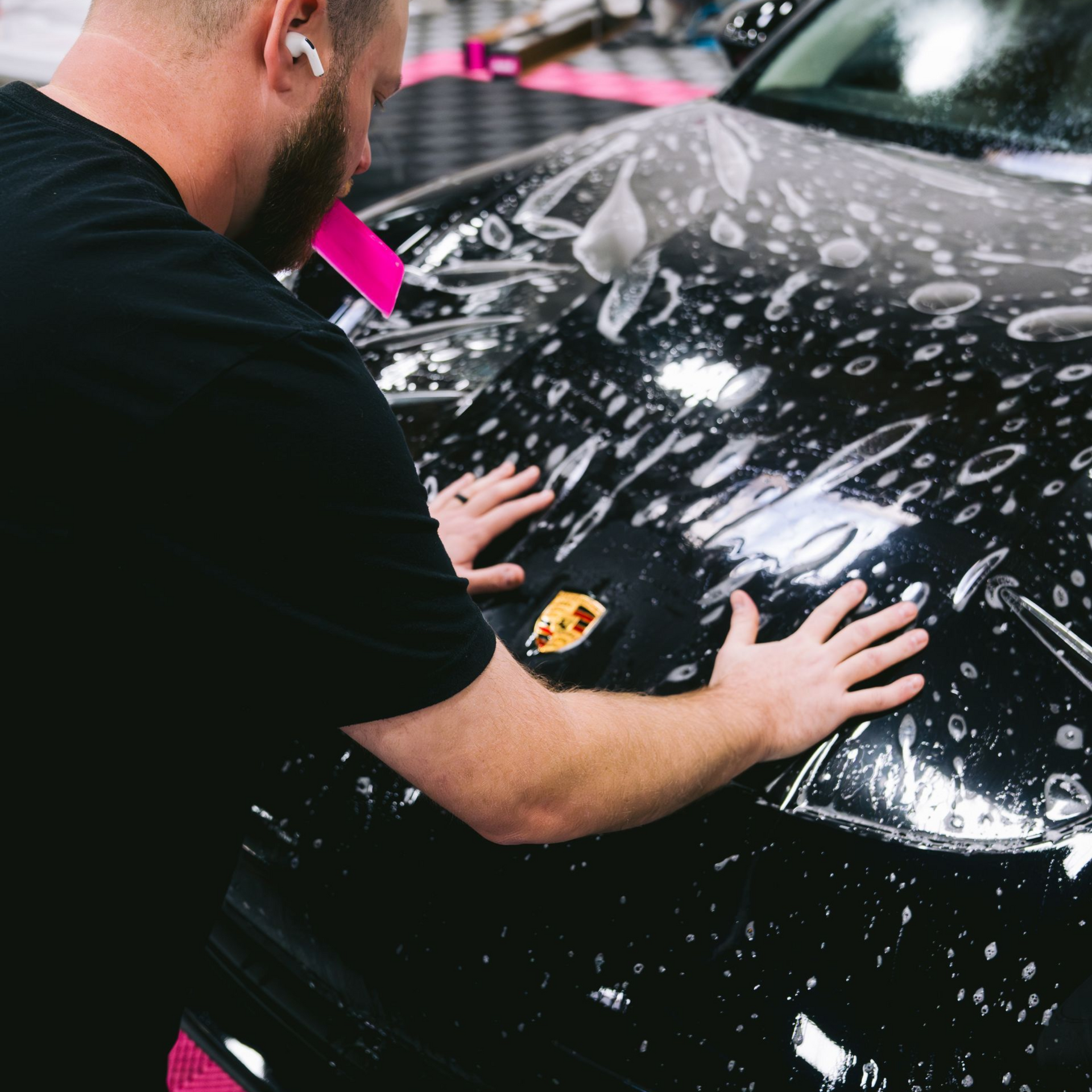A yellow sports car is parked in a garage.