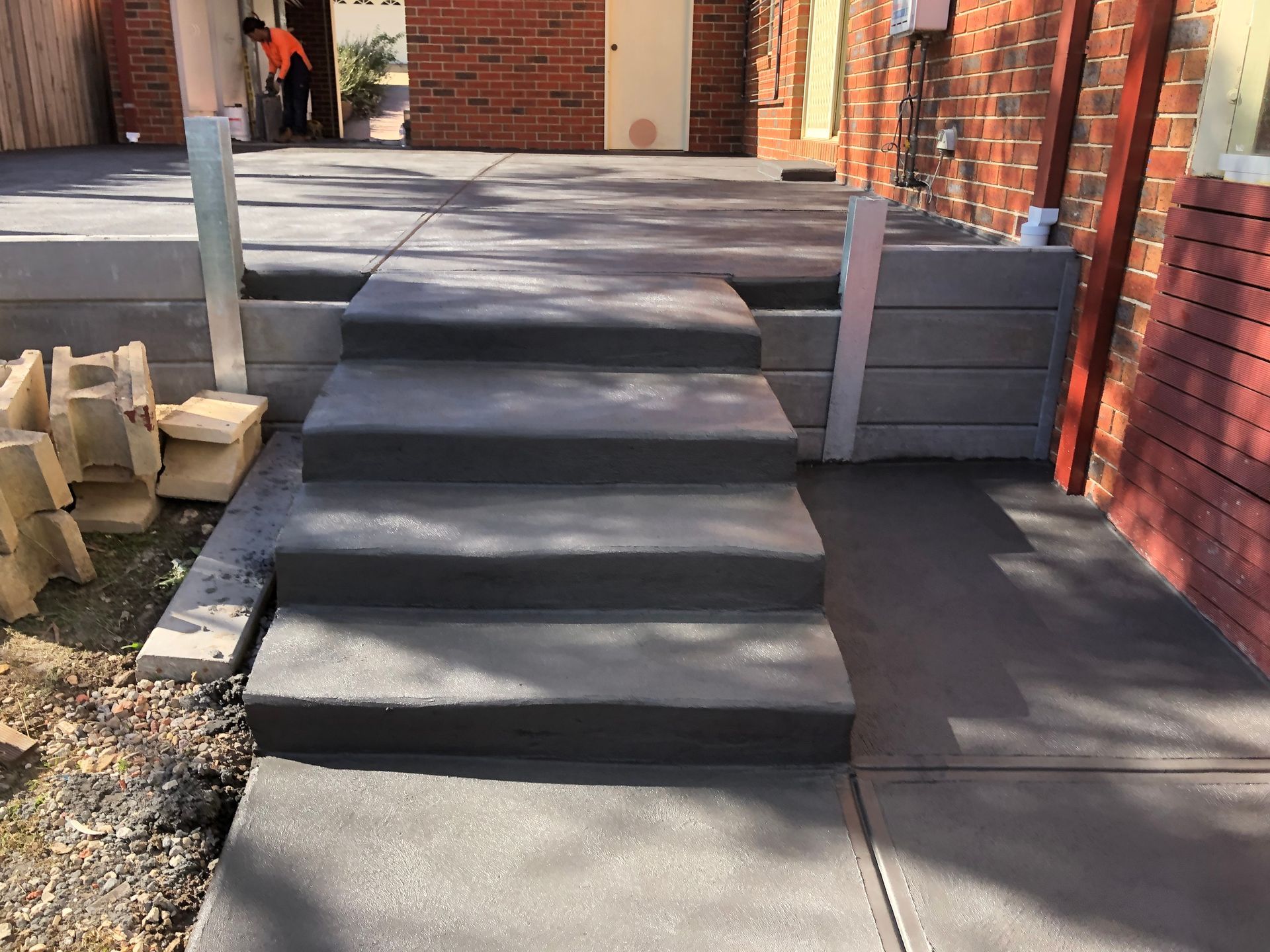 A set of concrete steps leading up to a brick building.