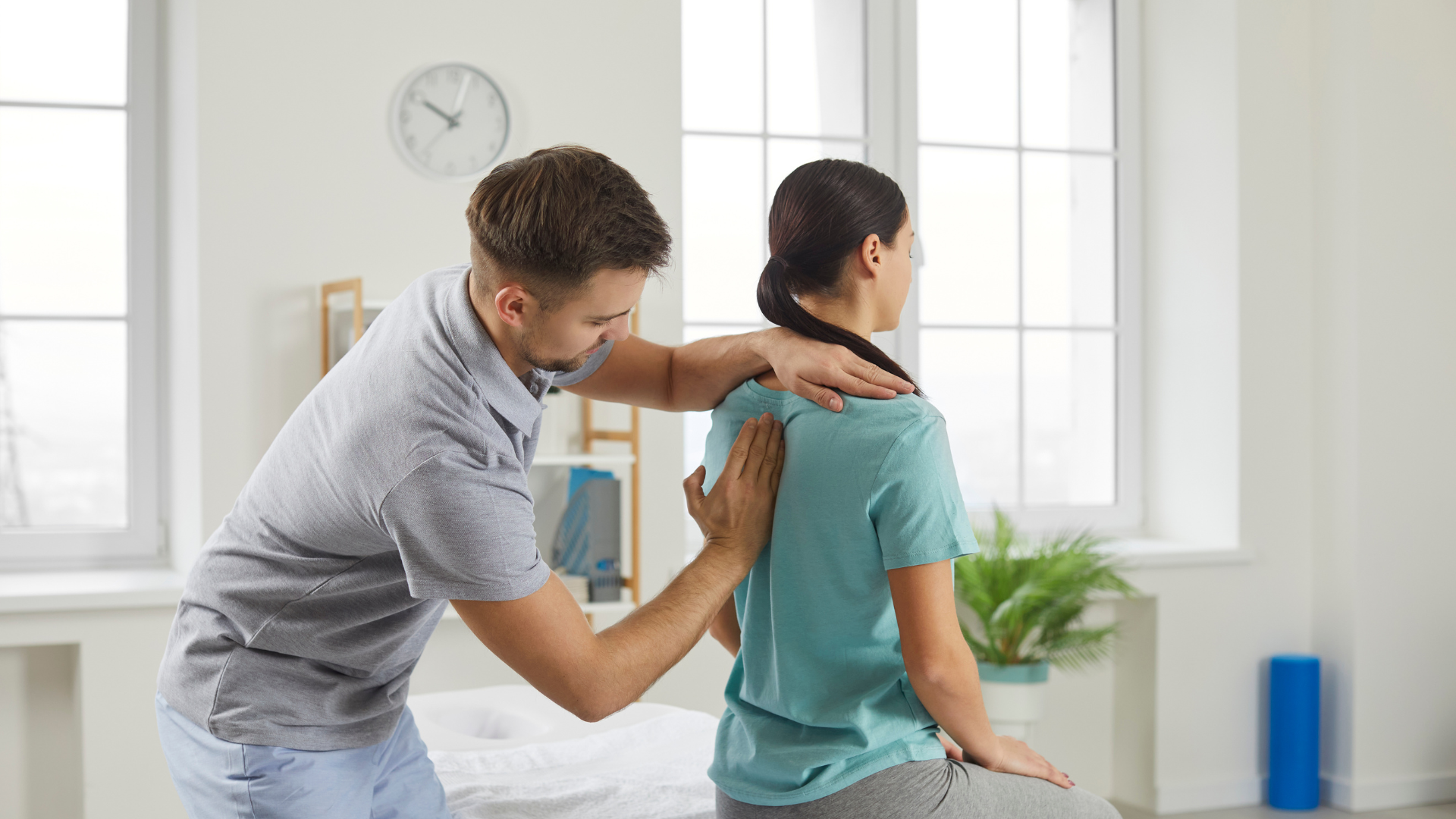 A man is giving a woman a massage on her back.