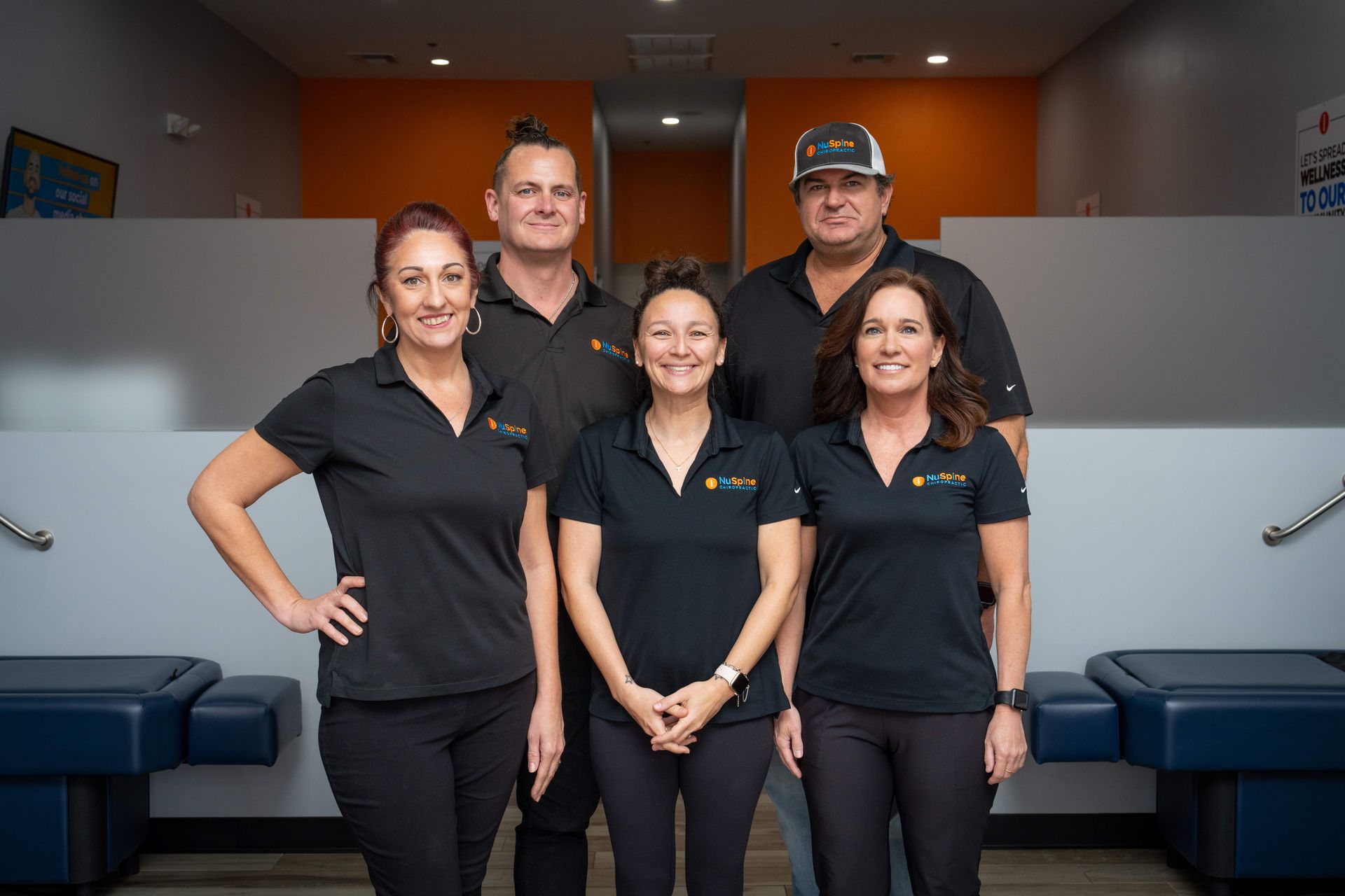 A group of people standing next to each other in a room.