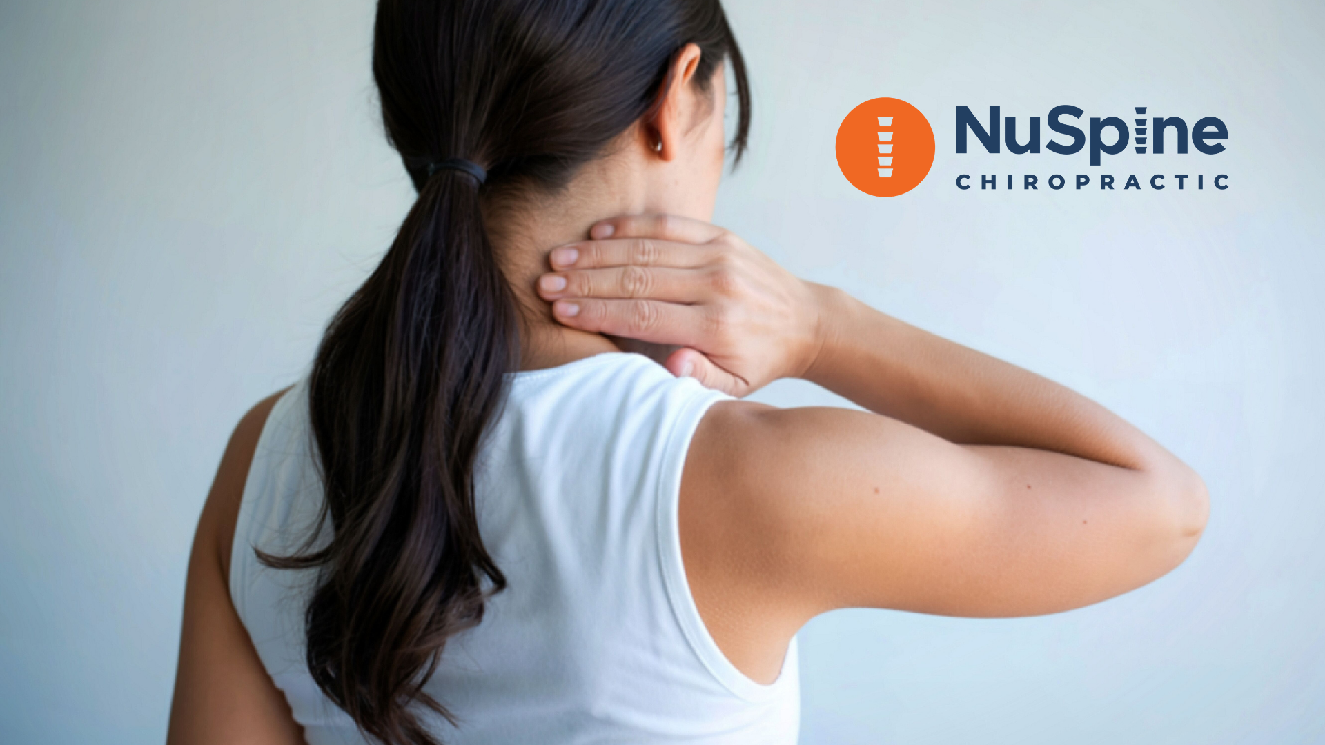 A person in a white top holding their neck in pain, with the NuSpine Chiropractic logo in the corner.