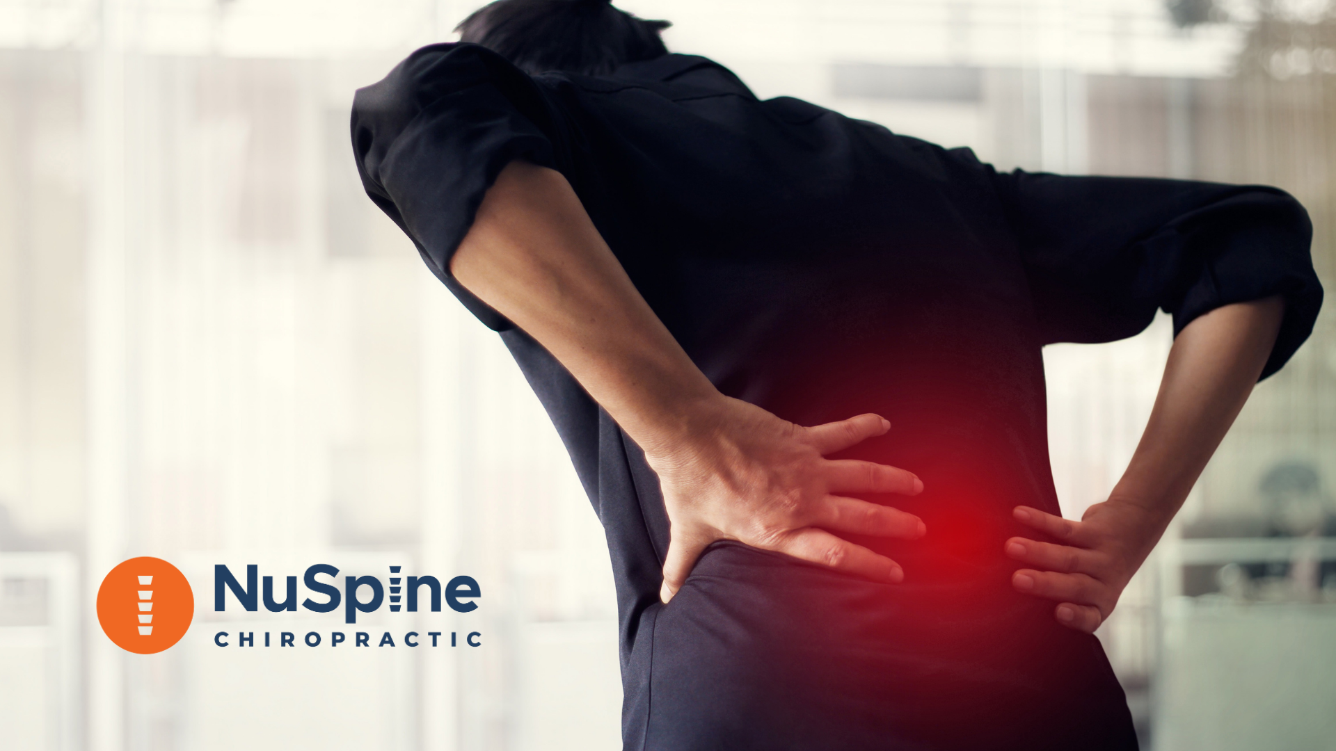 Person holding their lower back in pain; red glow highlights the area. NuSpine Chiropractic logo.