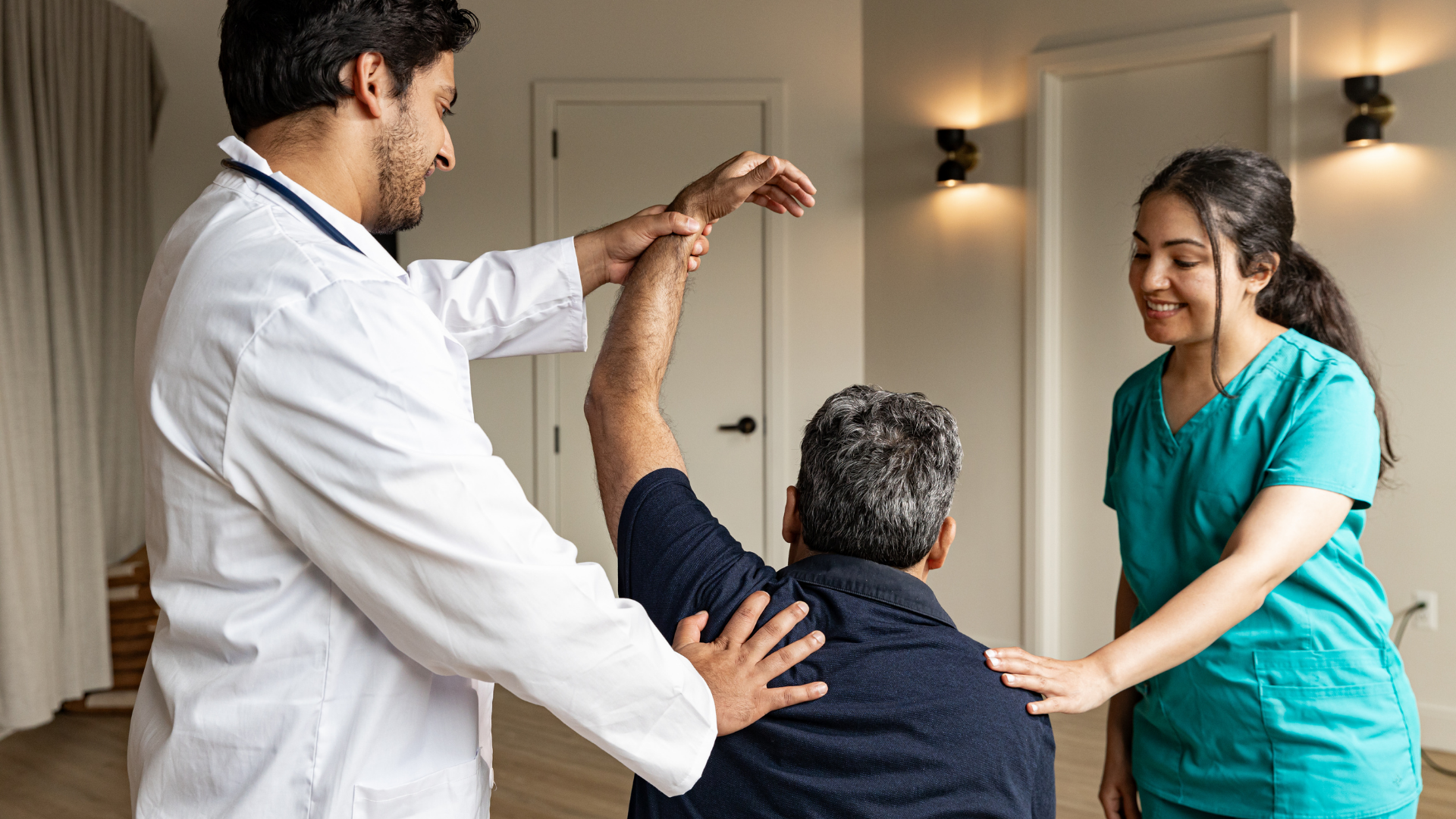 A man in a wheelchair is being helped by a doctor and nurse.