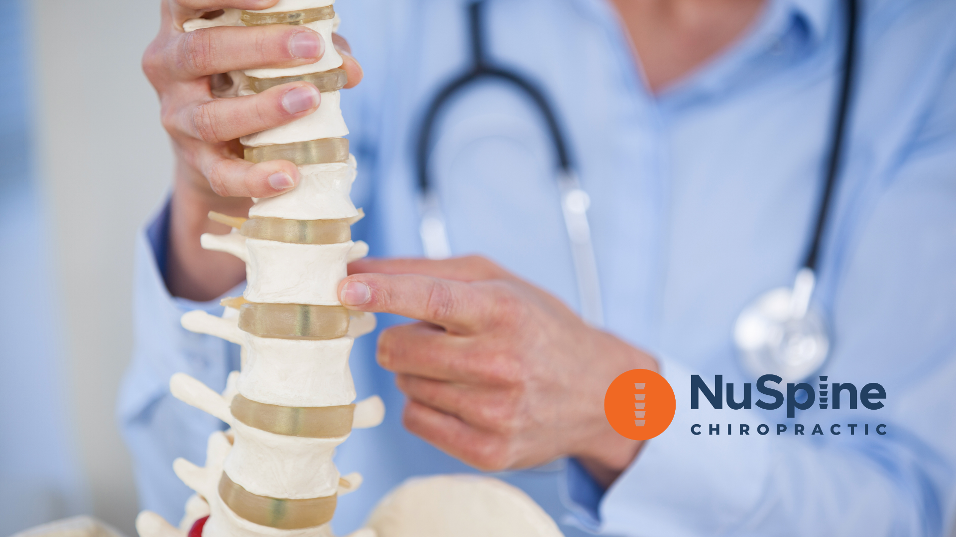 Doctor points to a model spine, stethoscope around their neck; NuSpine Chiropractic logo.