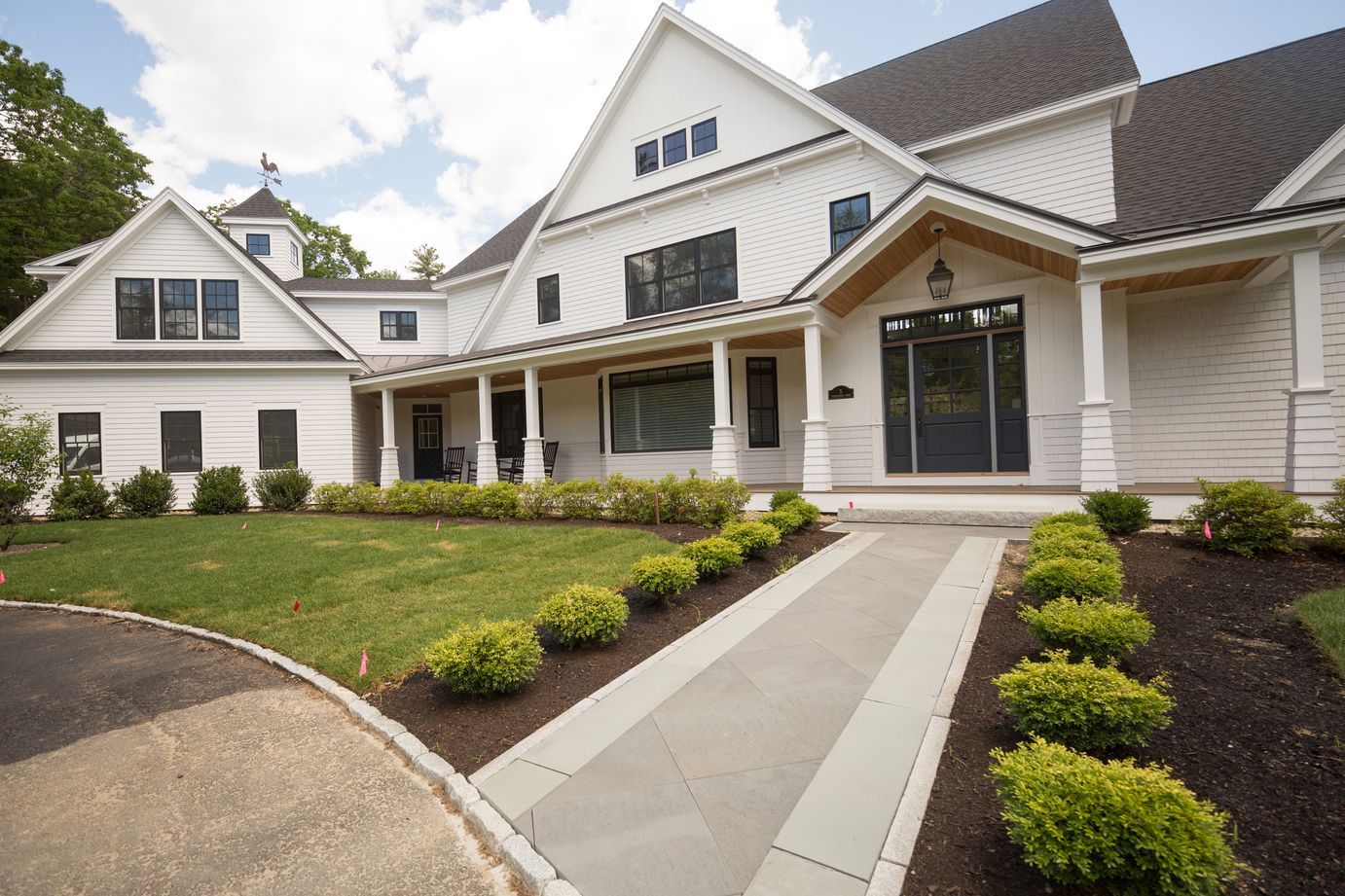 A large white house with a walkway leading to it