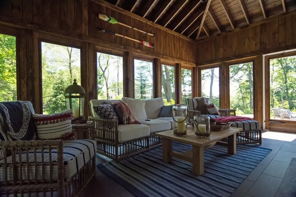A living room filled with furniture and a lot of windows.