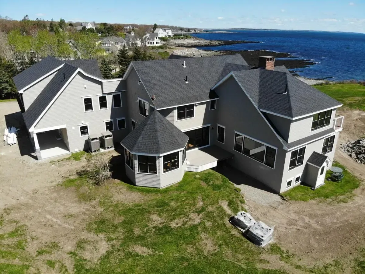 An aerial view of a large house with a view of the ocean.