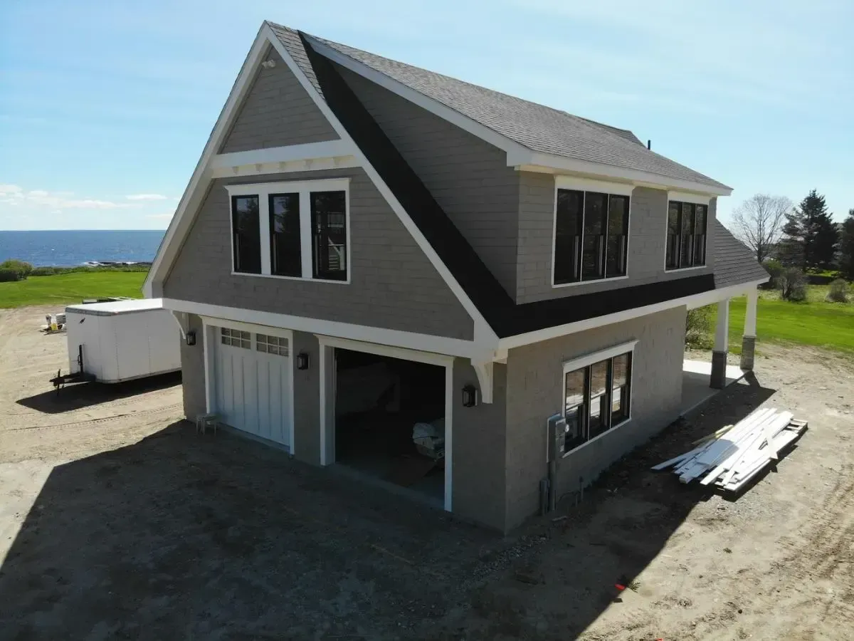 An aerial view of a house with a garage underneath it