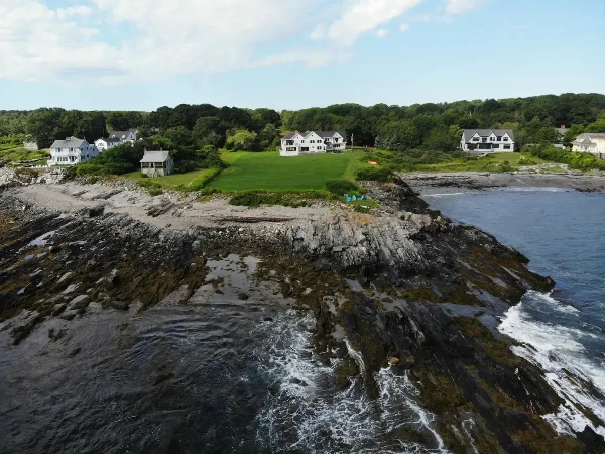 An aerial view of a cliff overlooking a body of water
