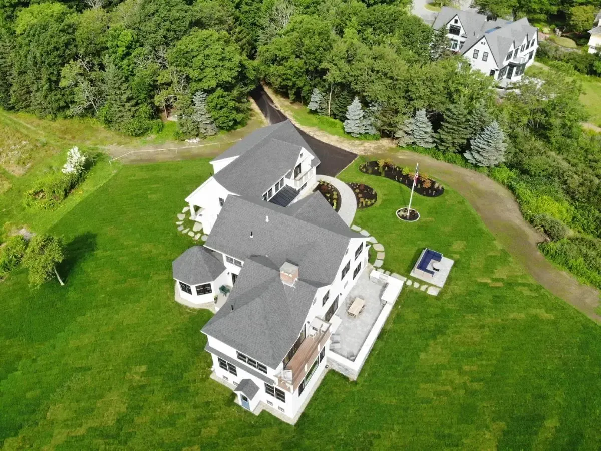 An aerial view of a large house surrounded by trees