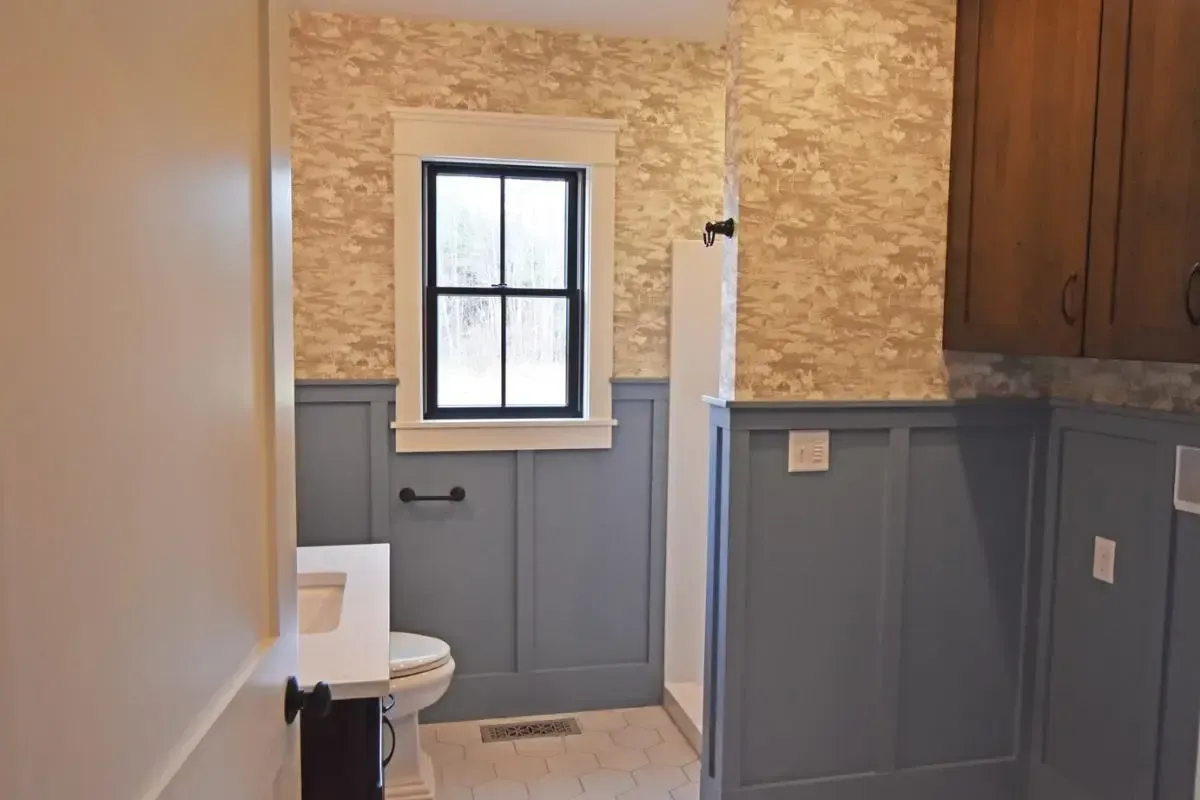 A bathroom with a toilet , sink , and shower.