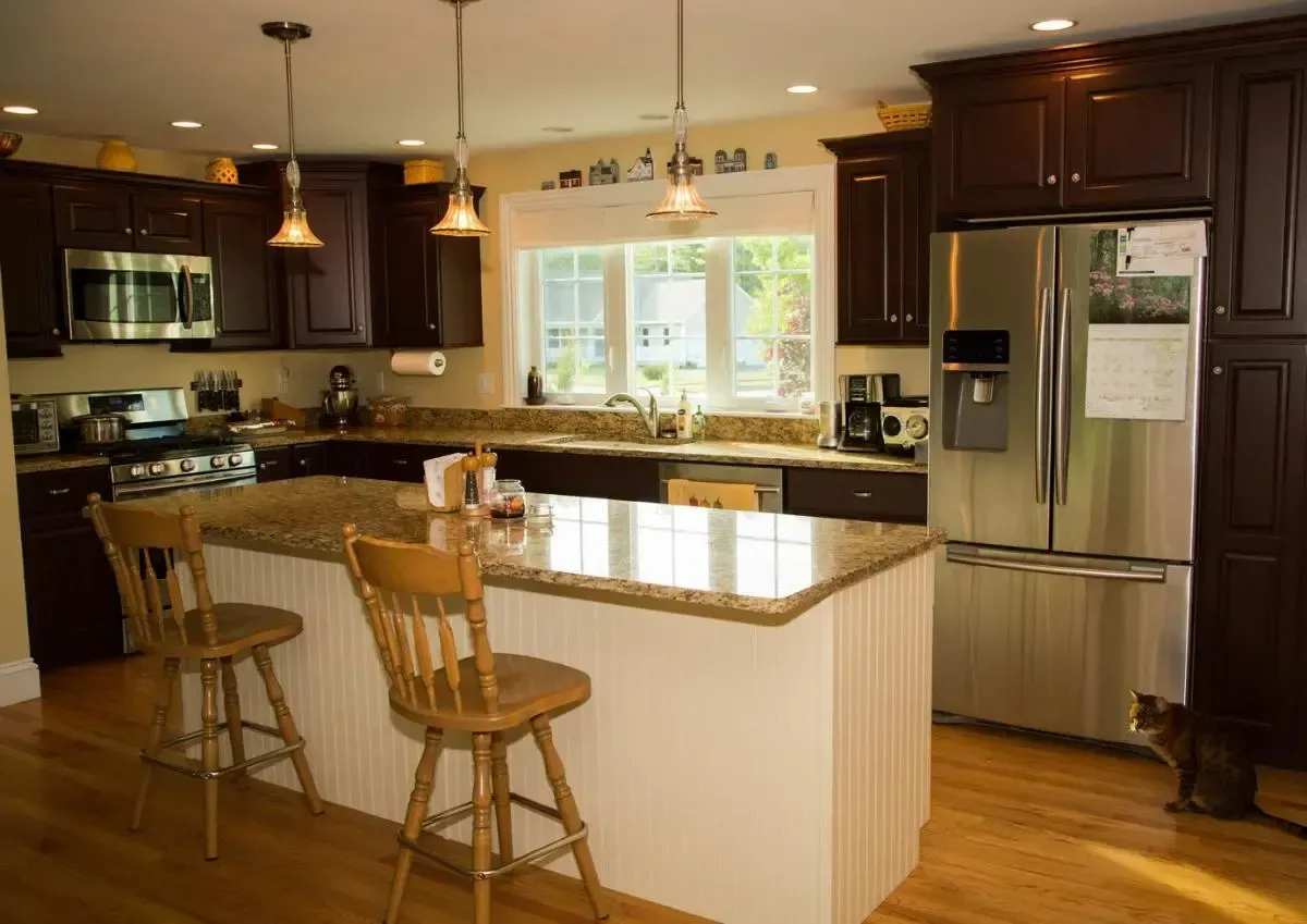 A kitchen with stainless steel appliances and wooden cabinets