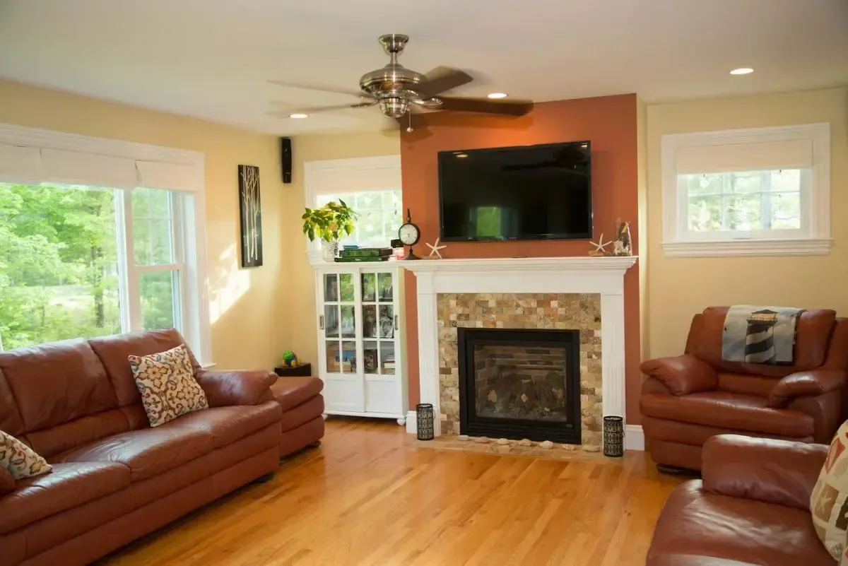 A living room with a fireplace and a flat screen tv
