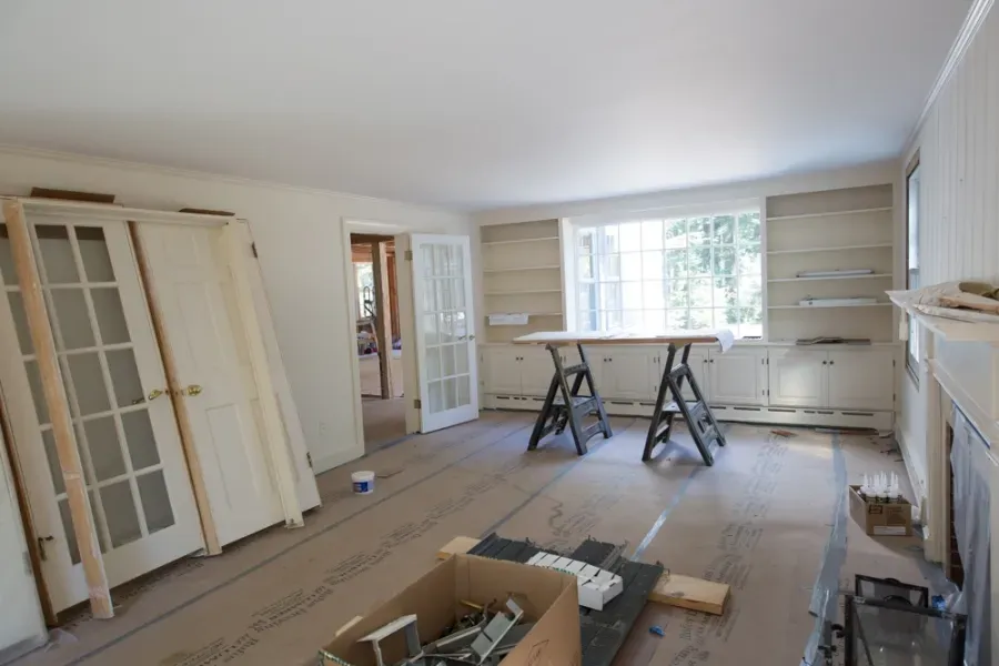 A living room under construction with a box on the floor