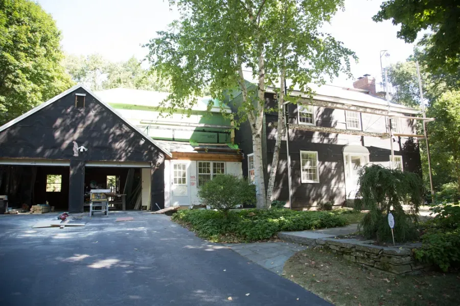 A house with a garage and a driveway in front of it