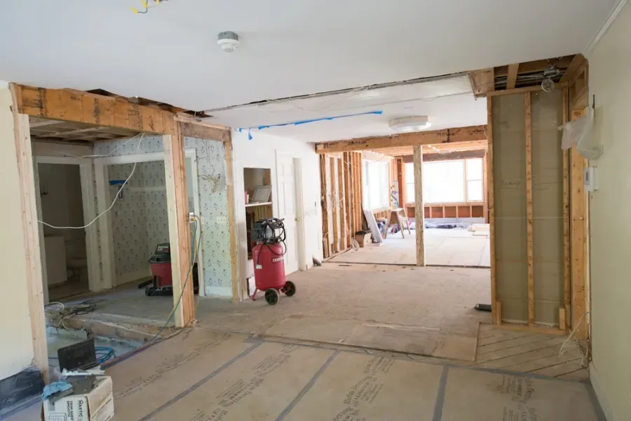 A large room with a vacuum cleaner in it is being remodeled.