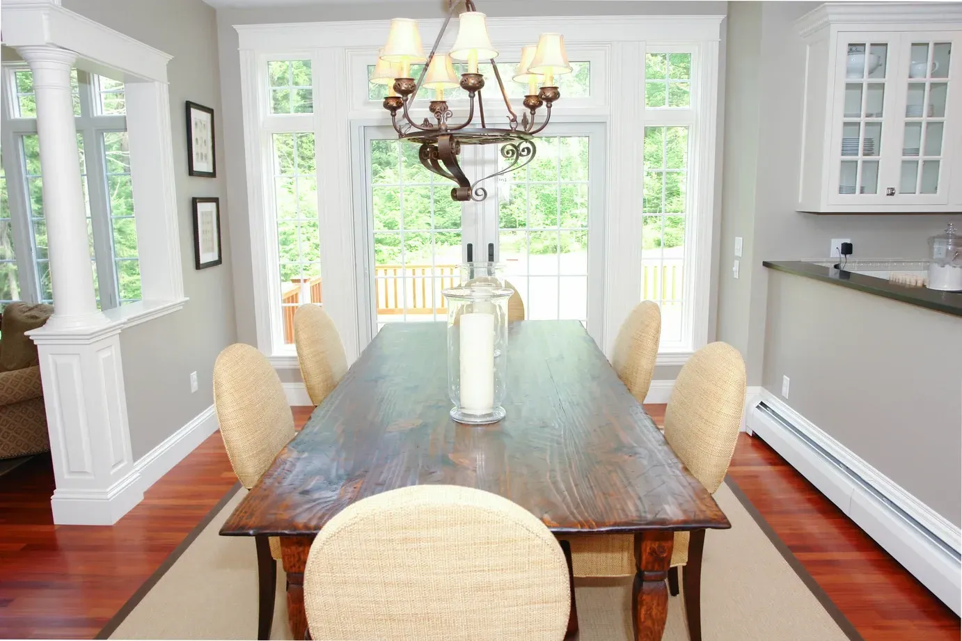 A dining room with a long wooden table and chairs
