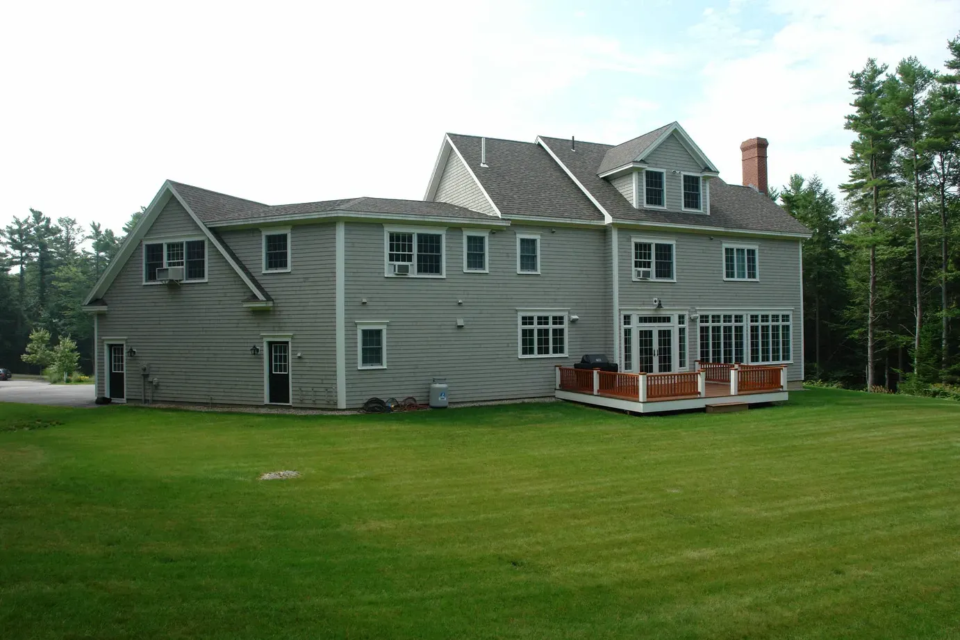 A large house with a large lawn in front of it