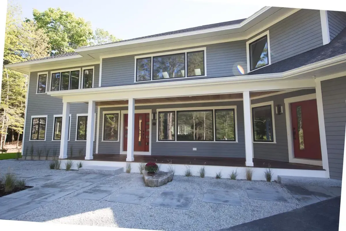A large gray house with red doors and windows